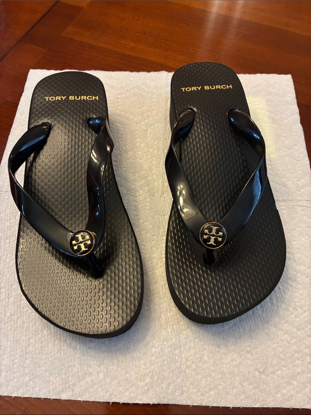 Tory Burch Black Flip Flop Sandals with Gold Logo Medallion. I’d say size 5. New